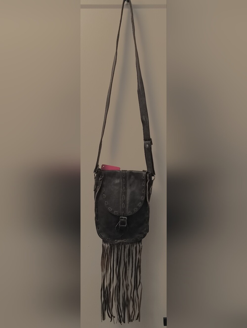 Women's Brown Fringe Leather Crossbody Bag with Magnetic Closure.